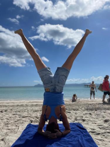 a woman doing a handstand on the beach at Casa Rural para descansar piscina cerca in Osor