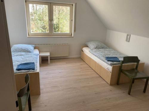 a small room with two beds and a window at Gästehaus am Biener See in Schepsdorf