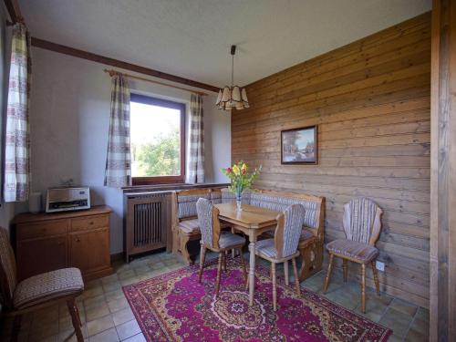 a dining room with a table and chairs and a window at Apartment in Fresach near Millstättersee with pool in Fresach