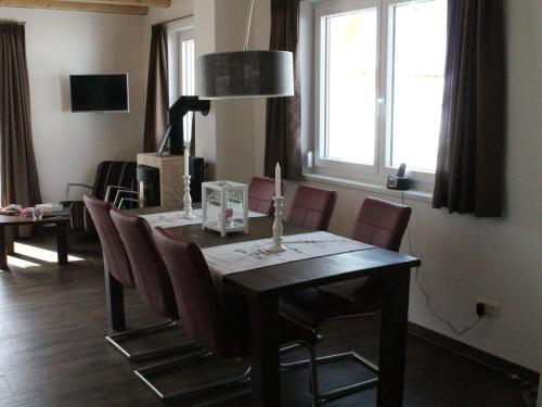 a dining room table with chairs and a window at Chalet in ski area in Koetschach-Mauthen in Kötschach