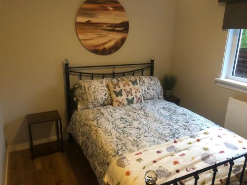a bedroom with a bed and a mirror on the wall at Ideally Located Modern Flat in Troon
