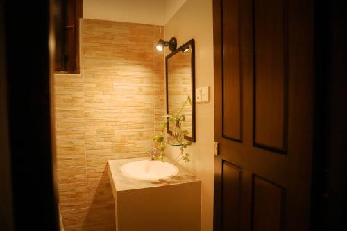 a bathroom with a sink and a mirror at The villaRo in Hikkaduwa