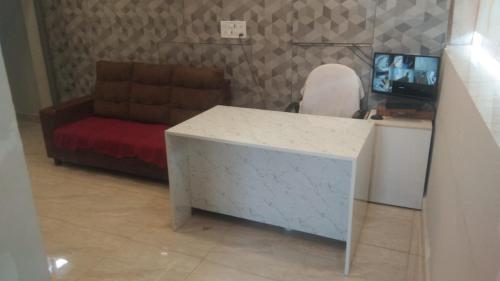a living room with a desk and a couch at HOTEL RAAJ GRAND in Chennai