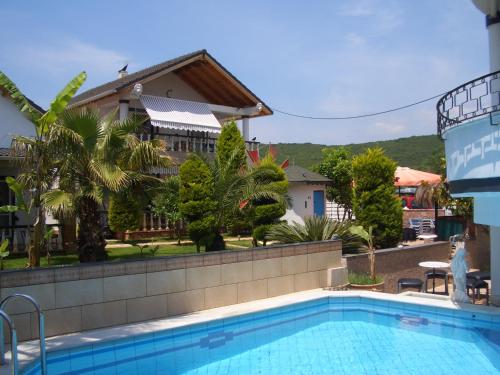 a swimming pool in front of a house at Aspri Villa in Ammoudia