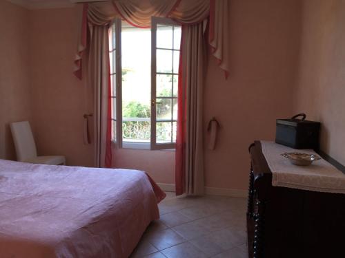 a bedroom with a bed and a window at Villa Manù B&B Chambre D'hote in Les Issambres