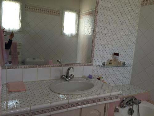 a person taking a picture of a bathroom sink at Villa Manù B&B Chambre D'hote in Les Issambres