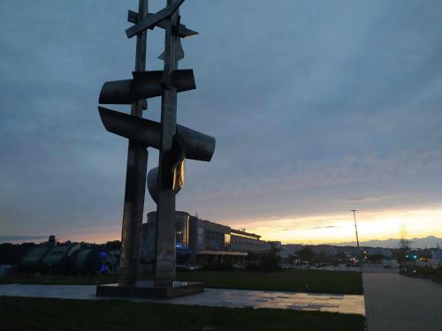 a statue of a street sign in a field at Pokoje ABC Centrum in Gdynia