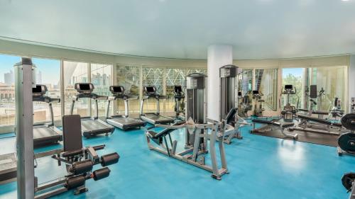 a gym with several treadmills and cardio machines at Mövenpick Hotel Al Khobar in Al Khobar