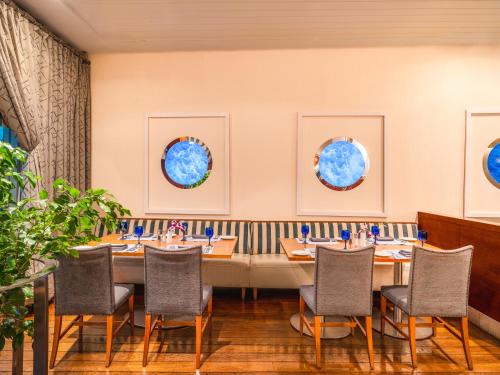 a dining room with a long table and chairs at Mövenpick Hotel Al Khobar in Al Khobar
