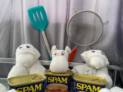 two stuffed animals are sitting next to cans of spam at MAMORI HOTEL in Allen