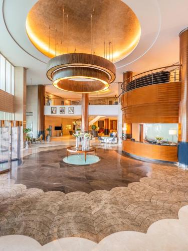a lobby of a hotel with a large room at Mövenpick Hotel Al Khobar in Al Khobar