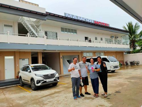 a group of people standing in front of a building at MAMORI HOTEL in Allen