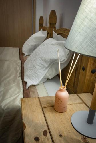 a lamp on a table next to a bed at Sol & Lar No stress in Santa Maria