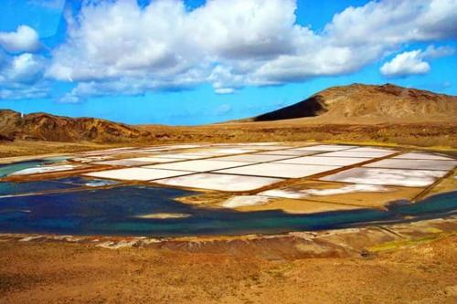 an aerial view of a field with water and mountains at Sol & Lar No stress in Santa Maria