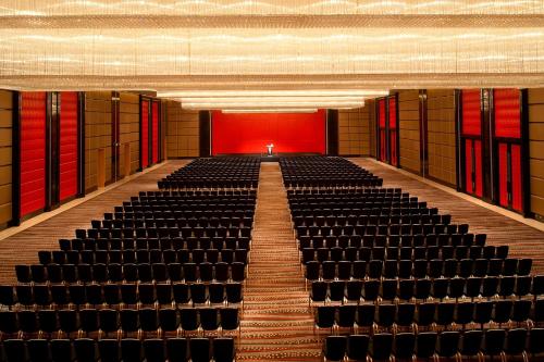 an empty auditorium with a row of empty seats at Le Méridien Qingdao l Instagrammable l CBD l Nearby seaside,nearby May 4th Square in Qingdao