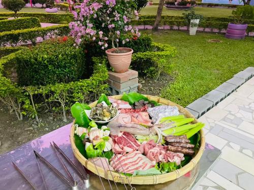 a tray of meat and vegetables on a table at XinFu Traveler Inn in Taiping