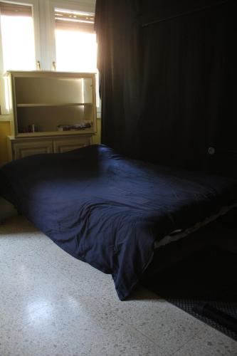 a blue bed in a room with a window at Vaticano in Rome