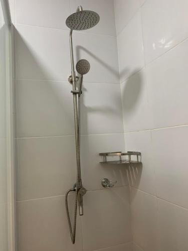 a shower with a shower head in a bathroom at MAMORI HOTEL in Allen