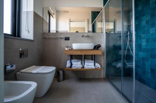 a bathroom with a sink and a toilet and a shower at Virdamuri - Etna Country Resort in Giarre