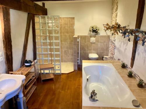 a large bathroom with a tub and two sinks at LE CLOS DU BENESTAR in Mauvezin-dʼArmagnac