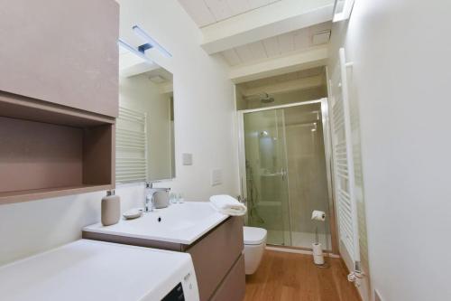 a bathroom with a white sink and a toilet at Loft 21 - Lussuoso ed Elegante a due passi dal Mare in Finale Ligure