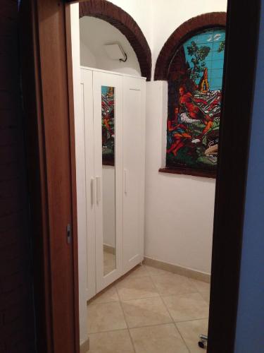 a hallway with a mirror and a painting on the wall at Il Raggio in Capri