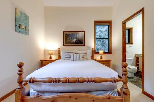 a bedroom with a bed and a bathroom with a mirror at Northern Lights 21 in Whistler