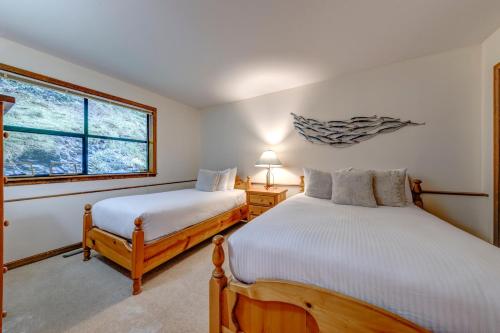 a bedroom with two beds and a window at Northern Lights 21 in Whistler