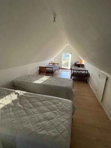 a room with four beds in a room with a attic at Maison de pêcheur vue mer exceptionnelle in Audinghen