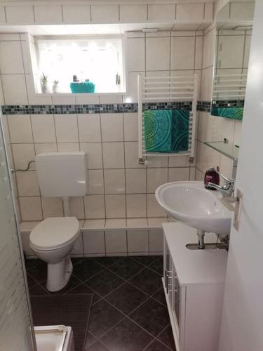 a bathroom with a toilet and a sink at Gemütliches Appartment in Homberg Stadtmitte in Homberg