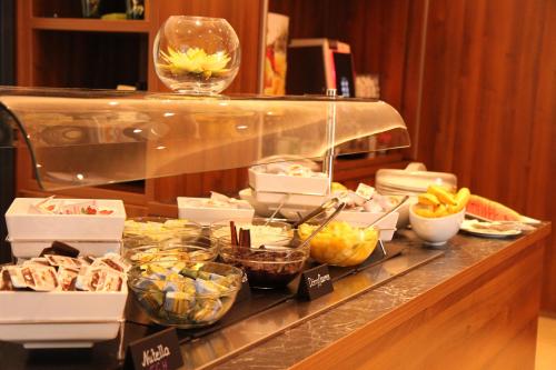 a buffet line with various food items on it at Seminarhotel Springer Schlössl in Vienna