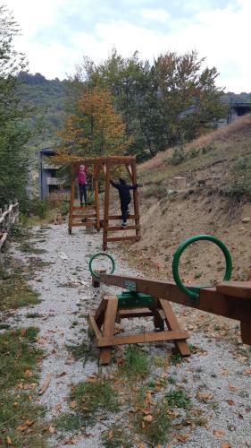 a dog is playing in a wooden playground at Mavrovo Centar Ski Staza in Mavrovo