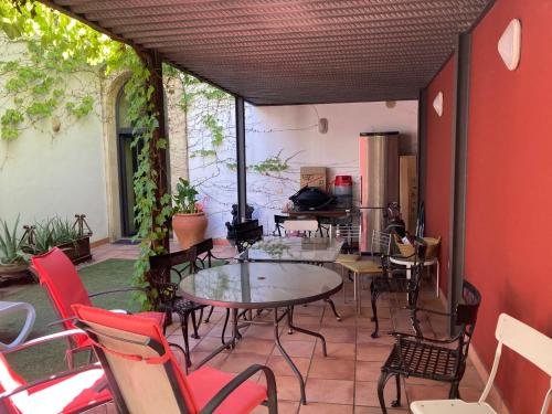 a patio with a table and chairs in a room at Casa Palaciega Centro Wifi in El Puerto de Santa María