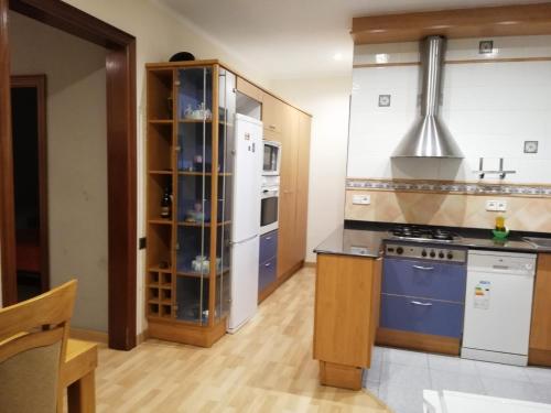 a kitchen with blue cabinets and a white refrigerator at Offer Economic apartment Barcelona in Barcelona