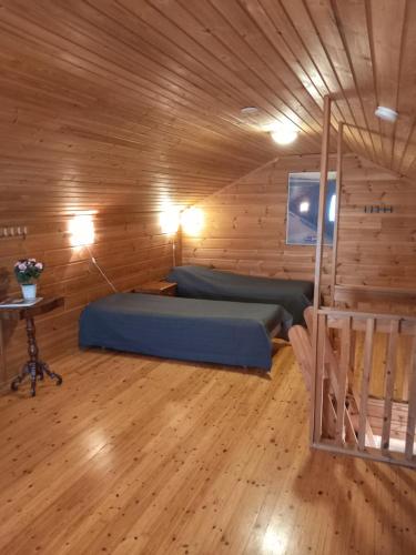 a bedroom with two beds in a wooden cabin at Himos, KOIVULA 25, center area in Jämsä