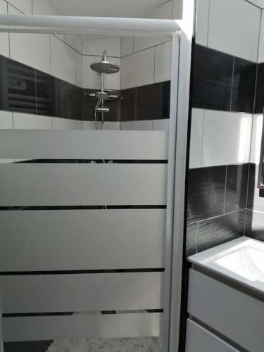 a bathroom with a sink and a mirror at Gîte Bin Benaise draps et serviettes compris in Pamproux