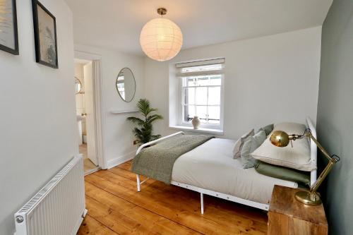 a bedroom with a bed and a window at Cwm Seren - Luxury Apartment in Crickhowell