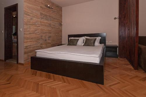 a bed in a room with a wooden floor at Villa Klia in Ohrid