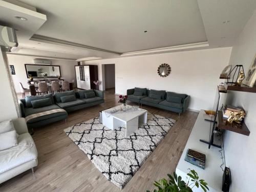 a living room with couches and a table and a rug at Al rehab city-new cairo in New cairo