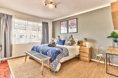 Cape Town的住宿－Trendy 1 bedroom flat in the heart of Green Point，一间卧室设有一张大床和一个窗户。