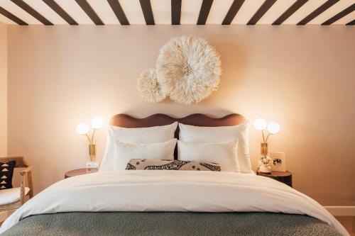 a bedroom with a large bed with white pillows at Clemonte Hotel - Your Reception-less Boutique Hideaway in Salzburg