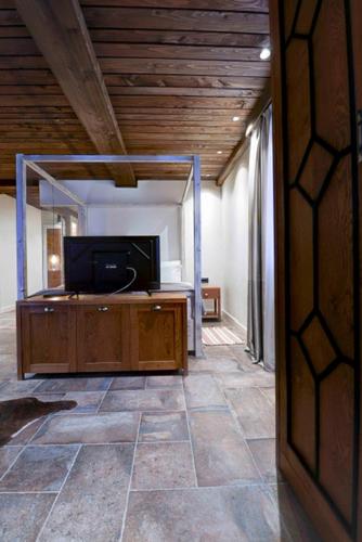a living room with a flat screen tv on a cabinet at Vlasinsko jezero VILA BEST in Surdulica