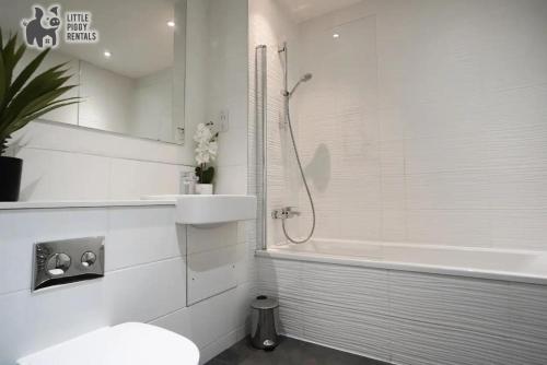 a bathroom with a shower and a toilet and a sink at Stunning Bedford Penthouse Suite (Sleeps 5) in Bedford