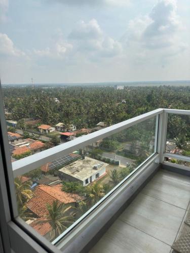 a view of a city from the balcony of a building at PL BEACH FRONT APARTMENT in Bopitiya