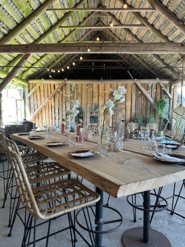 a long wooden table with chairs and vases on it at Pärapõrgu puhkemaja in Miila