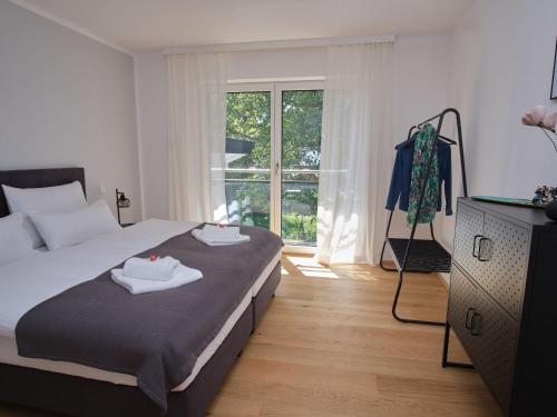 En eller flere senge i et værelse på NXT LIV I Kliniknah I 120qm mit Balkon I Nah zu Seen & Berge