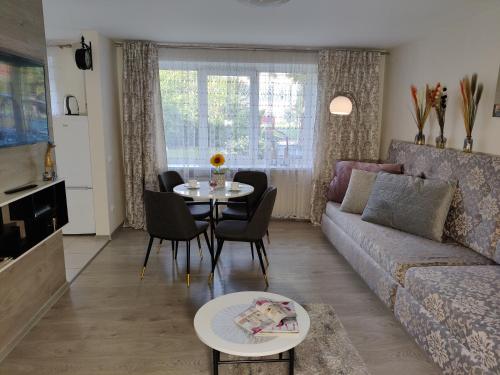 a living room with a couch and a table at Apartment Dalyce in Šiauliai