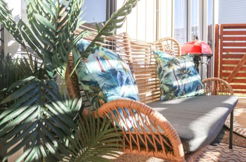 a table and chairs on a porch with a plant at Seascape Retreat: Time to Slow Down in Agnes Water