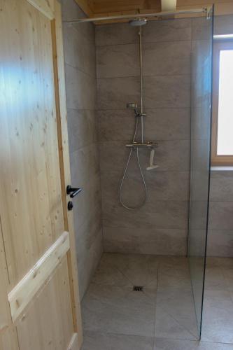 a bathroom with a shower with a glass door at Zirbenchalet Klippitz - Erholung mit Zirbenkraft in Bad Sankt Leonhard im Lavanttal