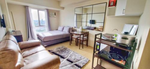 a living room with a couch and a table at Centrio Tower Studio Unit 19-03 in Cagayan de Oro